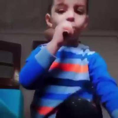 Kid is vaping while mom is right behind him