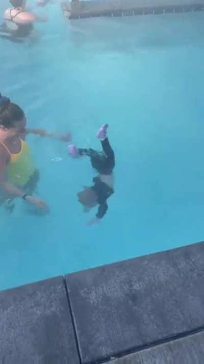 How did she knew that she has to hold her breath? And who are these people dumping children into water and watching like it's nothing??