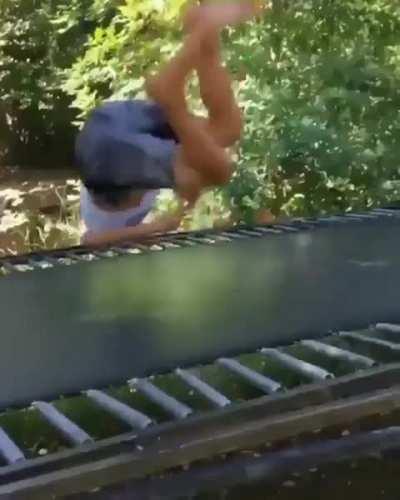 Complete scorpion jumping on a trampoline