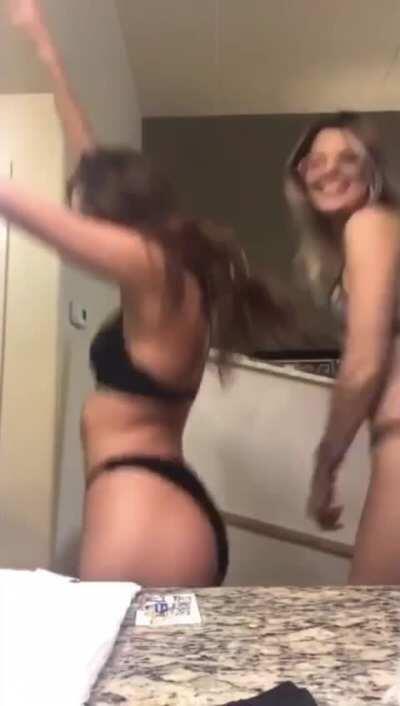 Flaunting her ass with a friend