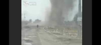 Army personnel laugh as old woman walks in danger zone in Iraq