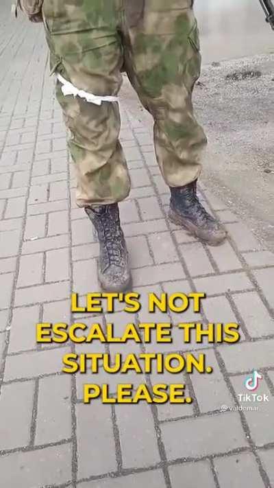 Ukrainian lady asks Russian occupier to put sunflower seeds in his pocket