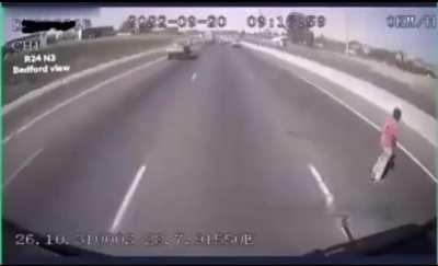 An guy tries to cross the highway and of course he gets hit by a car. South Africa