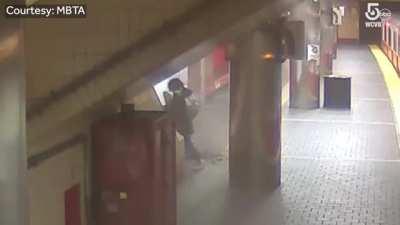 Ceiling panel almost falls on a woman getting off the subway in Boston.