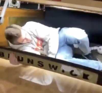 Idiot messing with the bowling ball machine