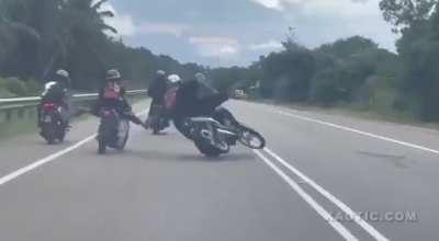Malaysian biker gets way too close, tumbles painfully after