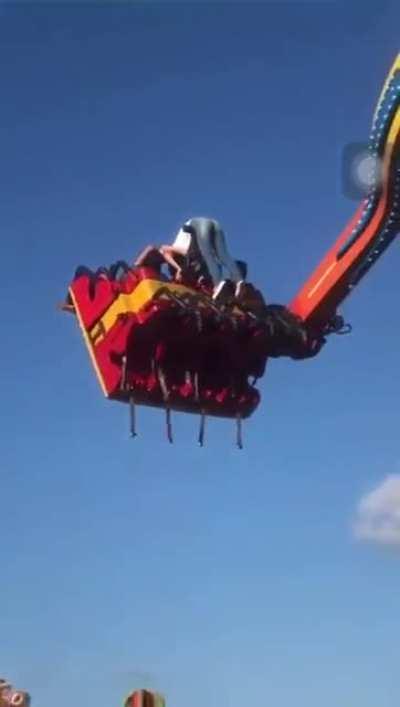 The girl hung on the carousel in the amusement park