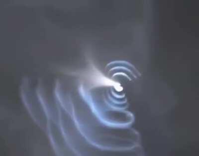 SpaceX's Falcon 9 returning to Earth, pulsing its cold gas attitude control thrusters.