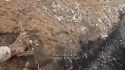 Russian soldier riding a dirt bike gets injured by a FPV hitting the ground next to him.