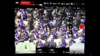 Leaked Drone footage of shackled and blindfolded Uighur Muslims led from trains.