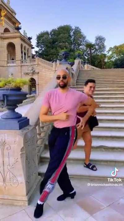 Guy tried to walk by as the stairs are blocked by a dancer