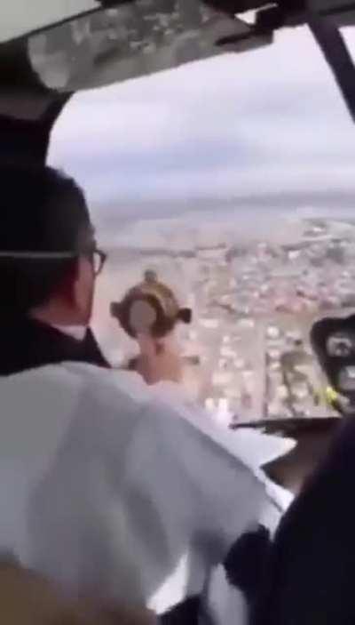 A priest blessed a city from a helicopter to help fight covid and someone did this