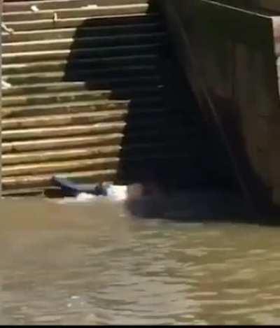 Man elegantly descending steps into the River Thames