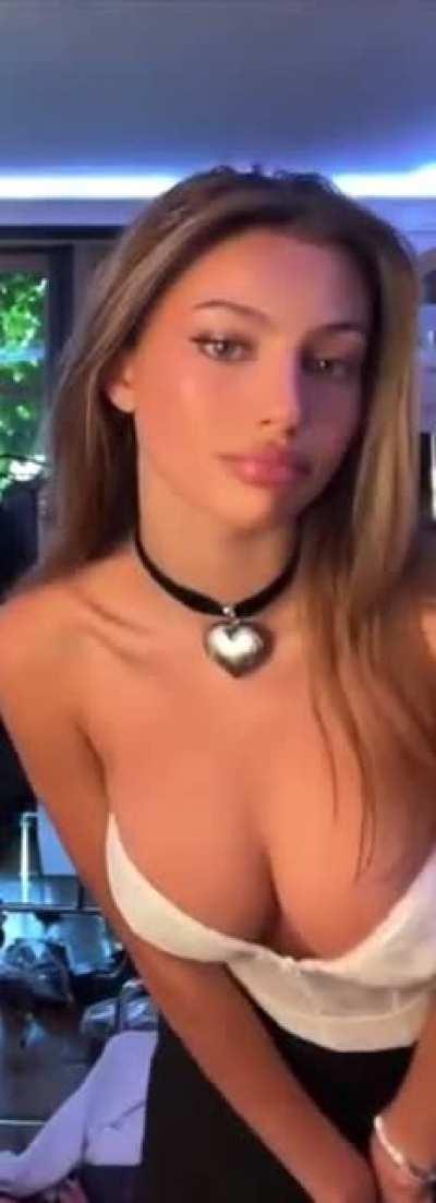 Bending over to show off her tits