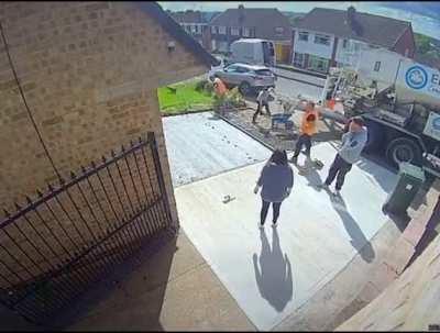 This dog's owners and the contractors are helpless as the dog runs on the cement work.