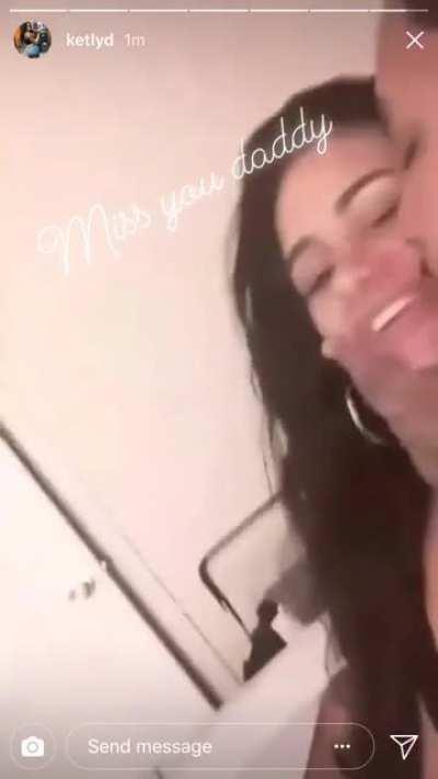 Ketly getting kissed on by a man