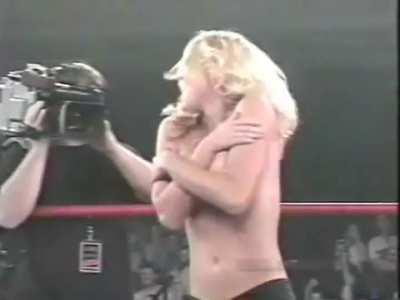Getting her top removed during a wrestling match