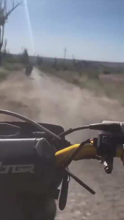 Russian assault rider on motorcycle captures arrival of a Ukrainian drone. Donetsk region.