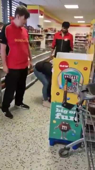 A woman attempting to steal from a Farmfoods store.