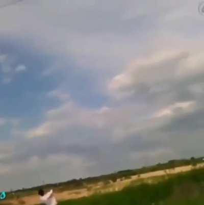 Kid throwing a copper wire-wrapped rock at a power line