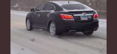 Driver Unaware of Ice Buildup on Rear Tire During Highway Travel