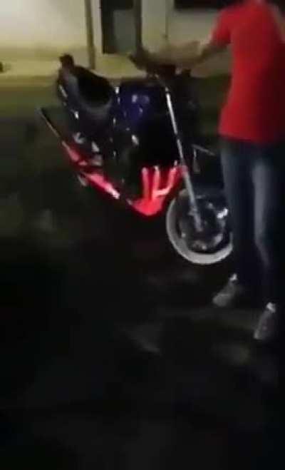 Revving motorcycle until the exhaust is red hot and it catches on fire