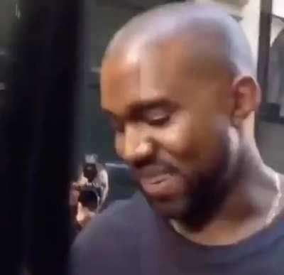 Kanye smiling over a Rep Yeezy