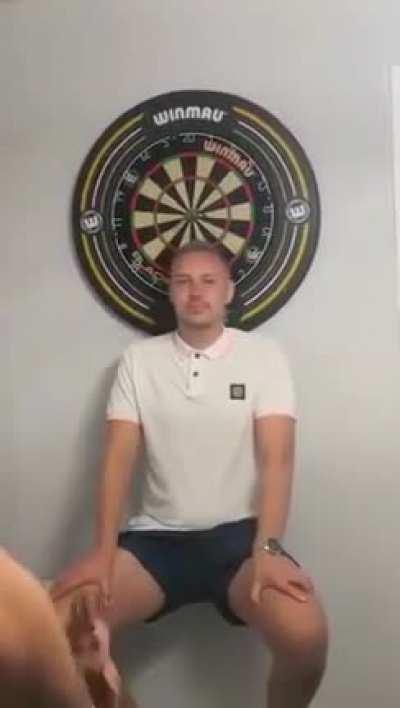 Sitting in front of a dartboard
