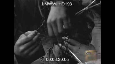 US Medics clean and stitch a soldier with a jaw wound - Normandy - 1944