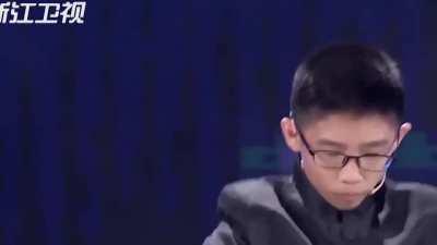 Kid solves Rubik's Cubes while juggling