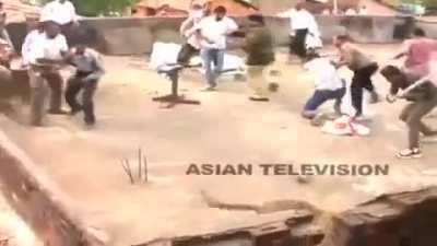 Indian men fixing broken roof shingles