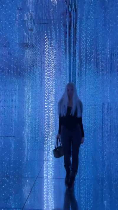 Polina Malinovskaya - Walking Through an Expo in Black Leather Pants under Blue Light (IG Story Clip)