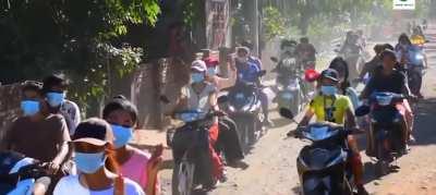 Protestors in Myanmar ride scooters to show their opposition to military rule