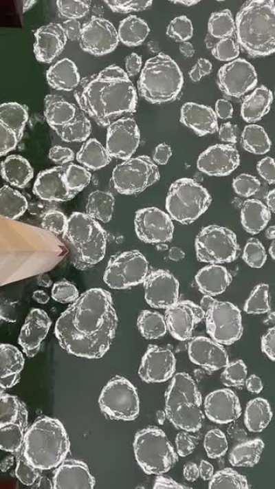 Ice pads breaking against bridge