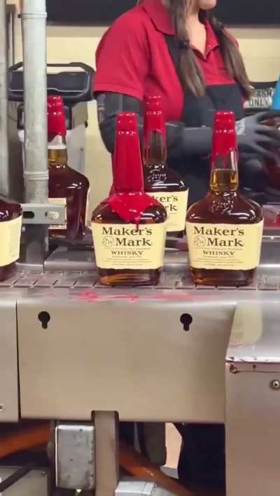 Whiskey bottles hand dipped in wax