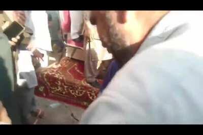 Men fighting over some cake. Multan, Pakistan.