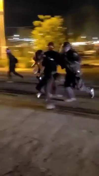 Woman getting beat with a baton in Portland