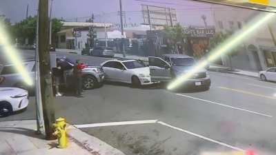 ICE hit & swarm a vehicle in LA immediately deploying tear gas and holding the occupants at gunpoint. The 2 men are US citizens per wife of one man