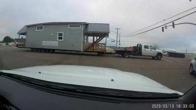 Wide load runs red light, snags overhead wires and blows out transformer.