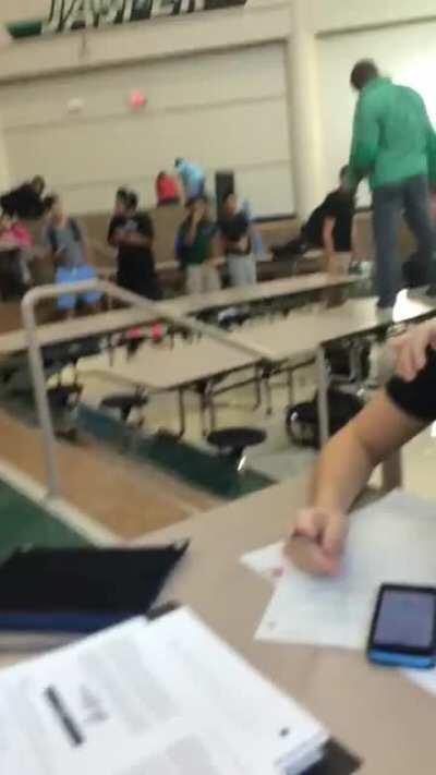 Trying to do an ollie in the school cafeteria