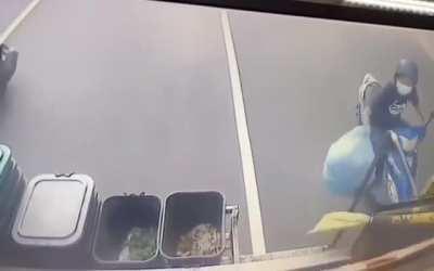 to throw a garbage at a moving garbage truck.