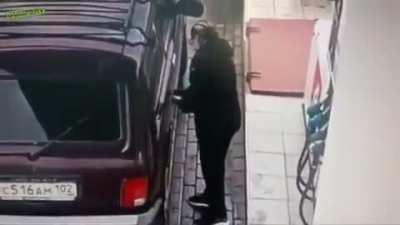 Woman and her wireless refueling at a gas station