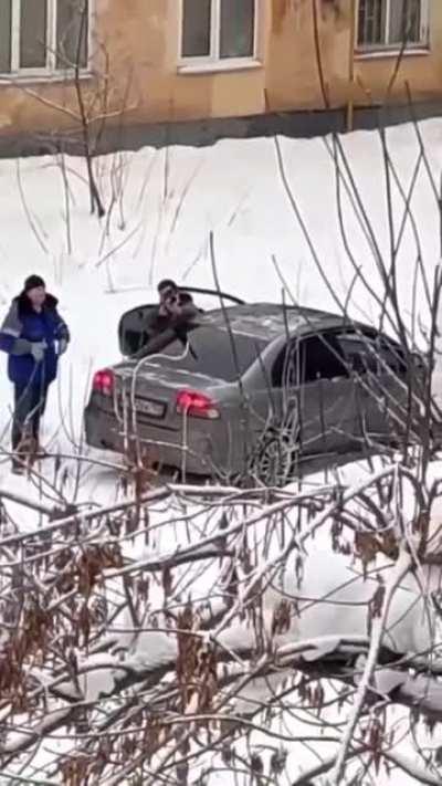 Municipal service workers knocking down icicles with a pneumatic gun