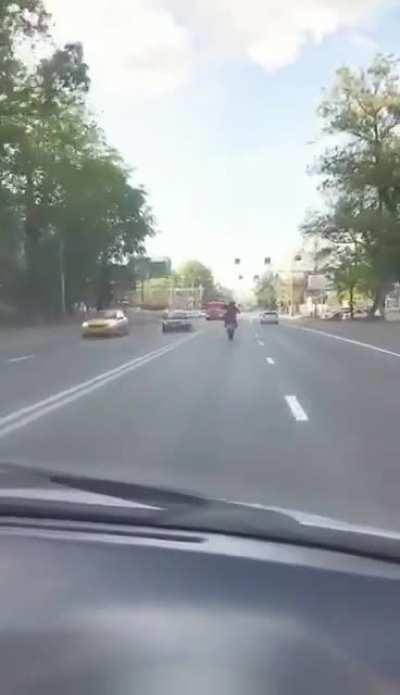 Wheelie on a busy road.