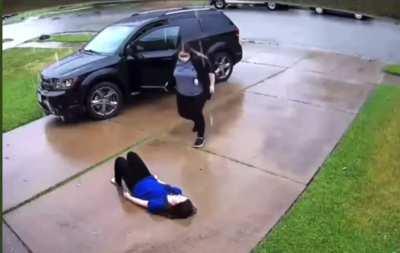 The girl in blue was having an anxiety attack. She called her mom, when her mom arrived she found her laying on the driveway in the rain. Instead of getting mad she gets down held her daughter’s hand and laid with her… in the rain… until her anxiety passe