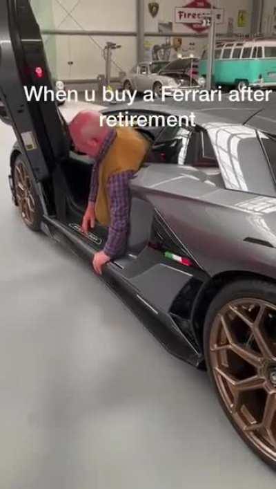 A man struggling to get out of his supercar