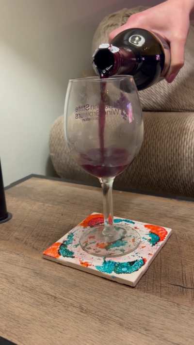 Pouring  myself, a glass of wine that my husband jerked off into and froze his load
