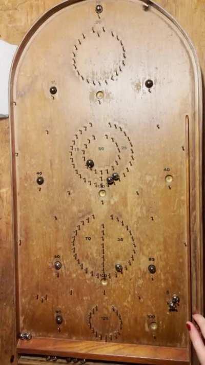 the sound of pinballs rolling and hitting nails on this hundred-year-old wooden pinball board (oc)