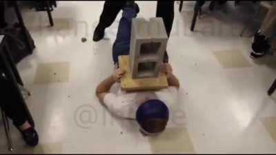Smashing a concrete bock placed on top of a person