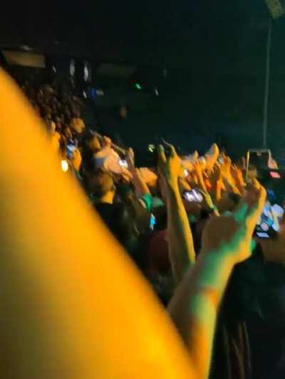 Wes crowd surfing while playing Faith.